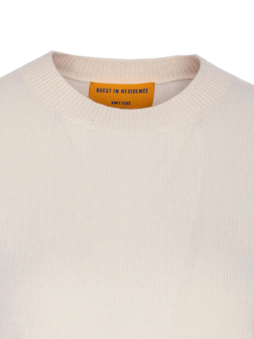 Close-up of the Shrunken Crew in Cream by Guest in Residence, showcasing its lightweight knit texture and high rib sleeve cuffs.