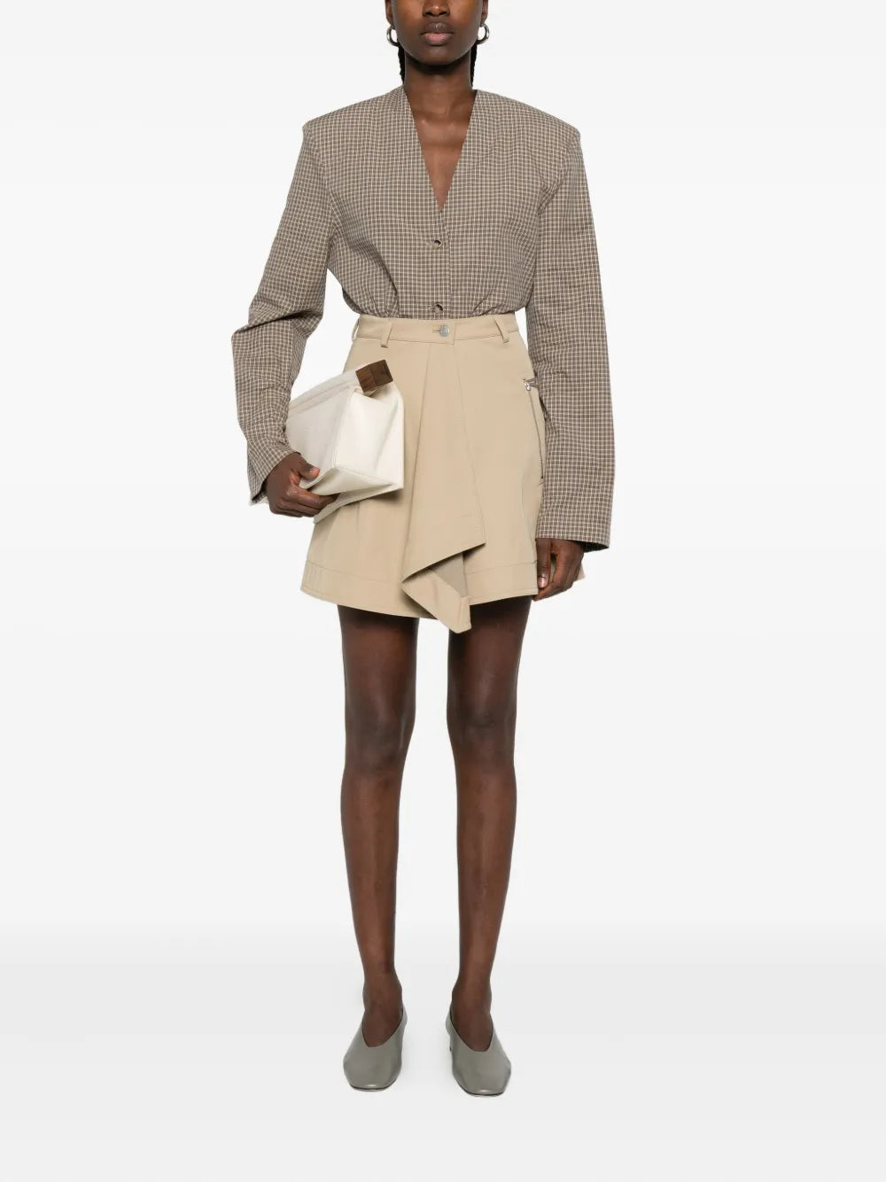 Close-up of the fabric and details of Inge Mini Skirt in Beige by Nanushka.