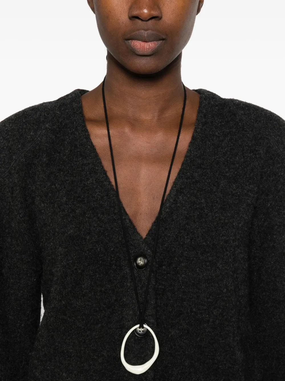 Nanushka Raddix Cardigan in Charcoal styled with minimalistic fashion, showcasing its versatile appeal.