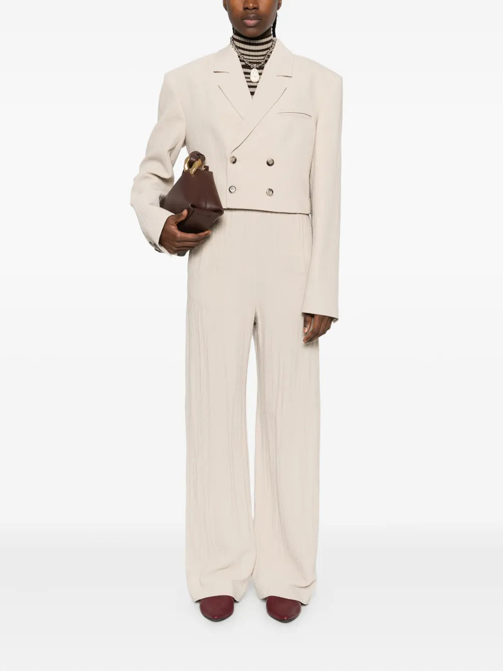 Close-up view of Arvenn Pants in Sand featuring the fluid shape and fine details of Nanushka's design.