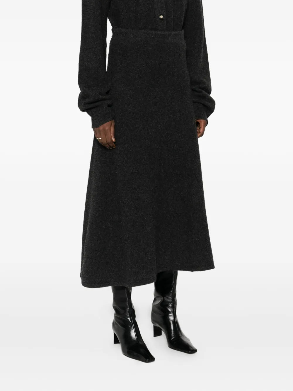 Priel Midi Skirt in Charcoal modeled on a mannequin, highlighting its elegant a-line silhouette.