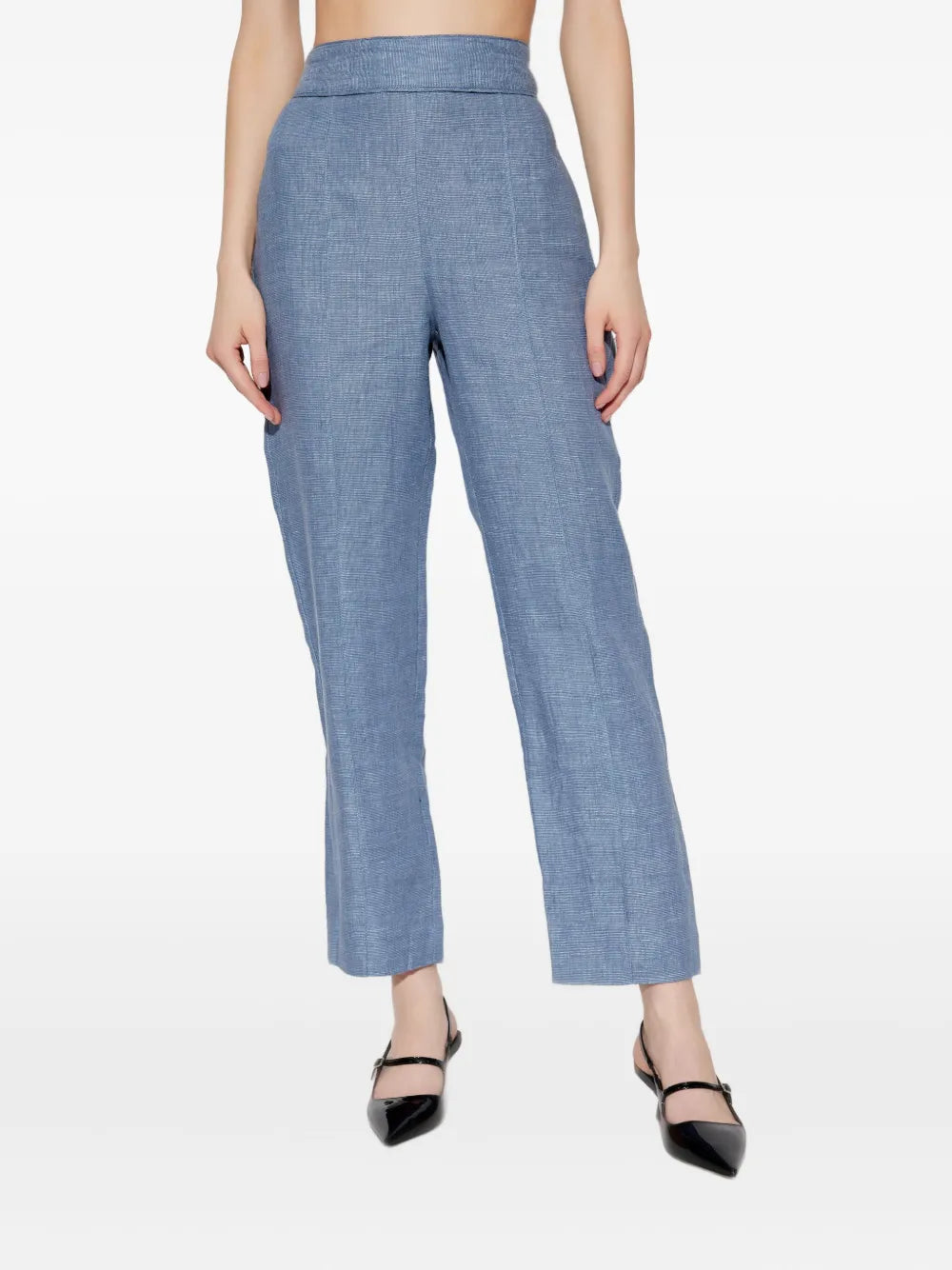 Model wearing Thea Trousers in Steel Blue outdoors, demonstrating the versatile styling options for casual and formal occasions.