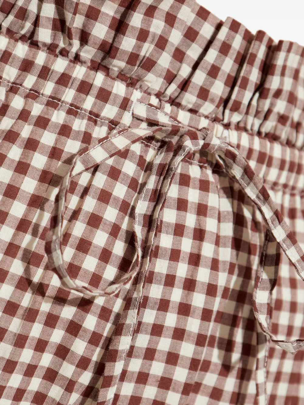 Model wearing Callie Shorts in Petite Mocha Gingham paired with matching Callie Blouse, demonstrating versatile styling options.