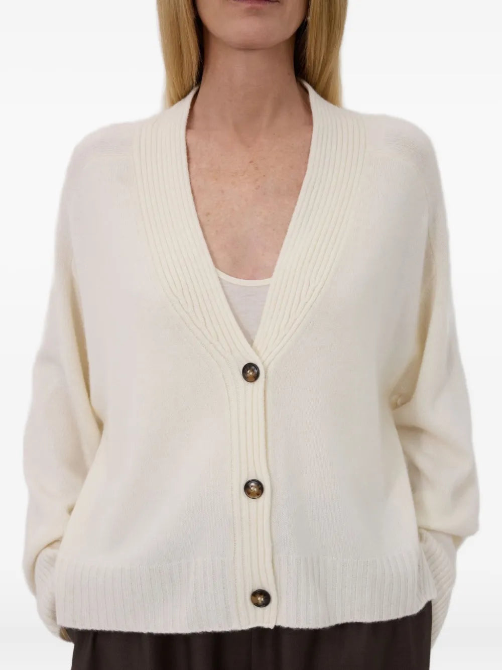 The Kaia LDS V Neck Cardigan in Ivory, made from 100% cashmere, showcased in a lifestyle setting.