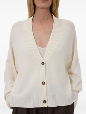 The Kaia LDS V Neck Cardigan in Ivory, made from 100% cashmere, showcased in a lifestyle setting.
