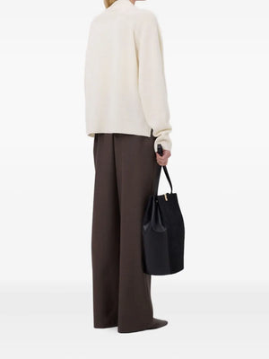 A beautiful shot of the Kaia LDS V Neck Cardigan in Ivory paired with stylish attire, perfect for a chic look.
