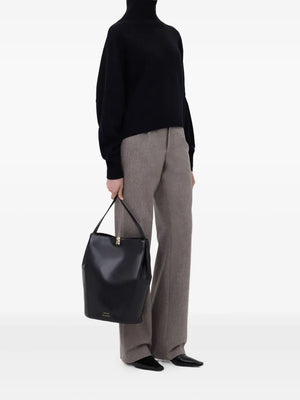 Model wearing the Luke Stand Collar Sweater in Black by Loulou de Saison styled for a casual day out.