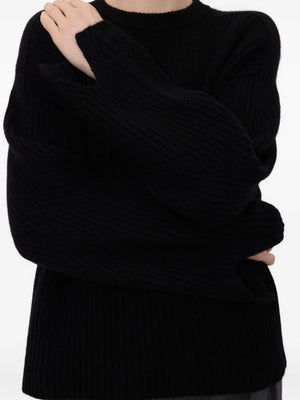 Flat lay of Axel Ribbed Cashmere Sweater in Black, emphasizing its classic crew neck design and luxurious fabric.