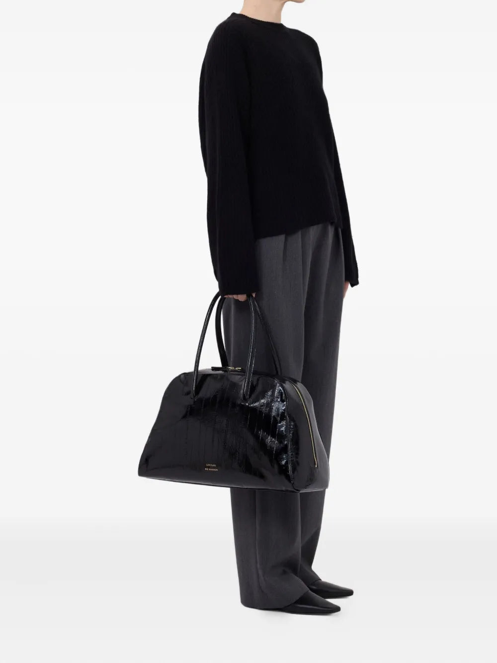 Model wearing Axel Ribbed Cashmere Sweater in Black, styled casually for a relaxed look.