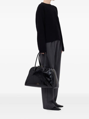 Model wearing Axel Ribbed Cashmere Sweater in Black, styled casually for a relaxed look.