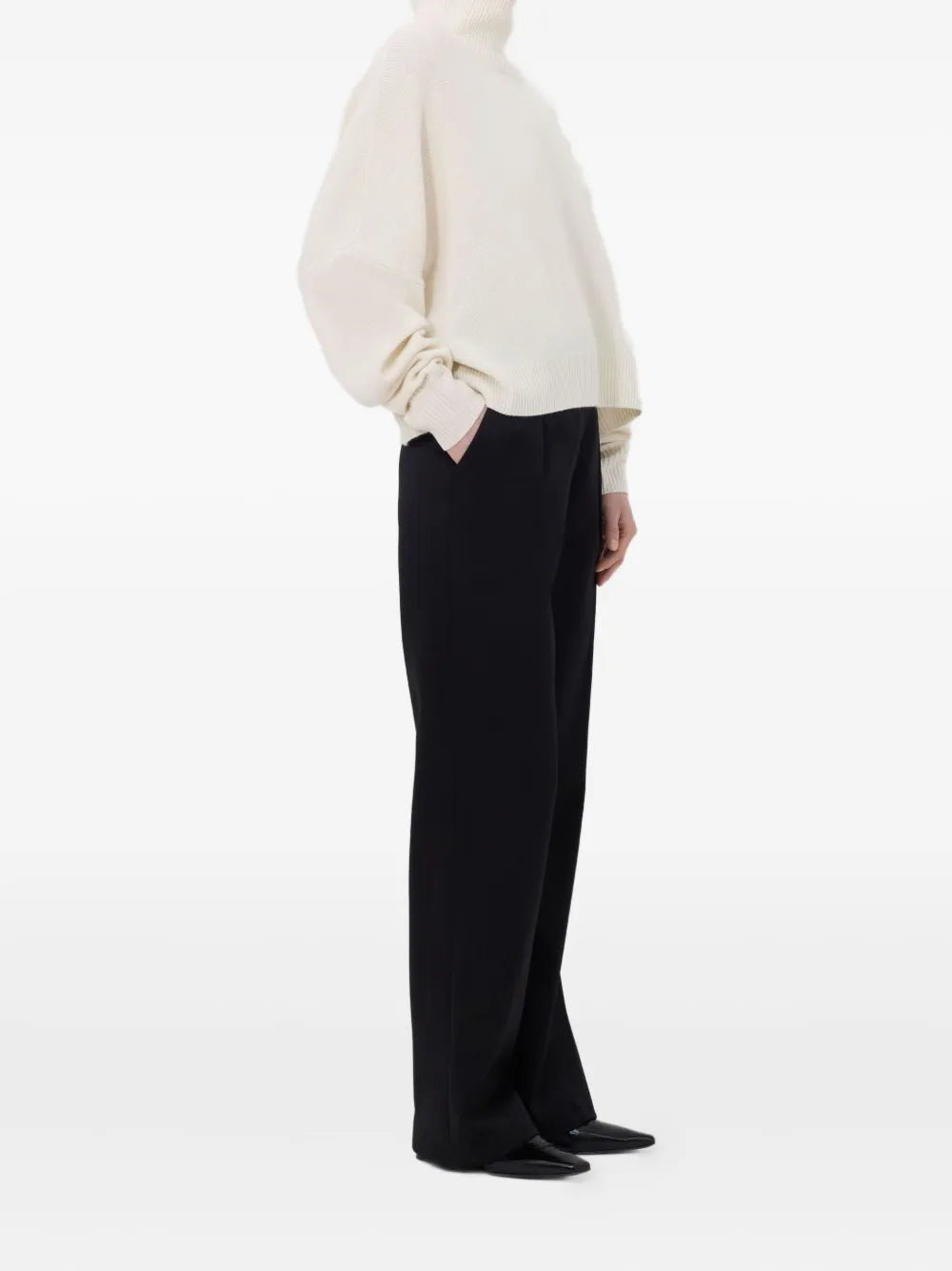 Model wearing the Luke Stand Collar Sweater in Ivory, styled with a chic outfit for a casual look.
