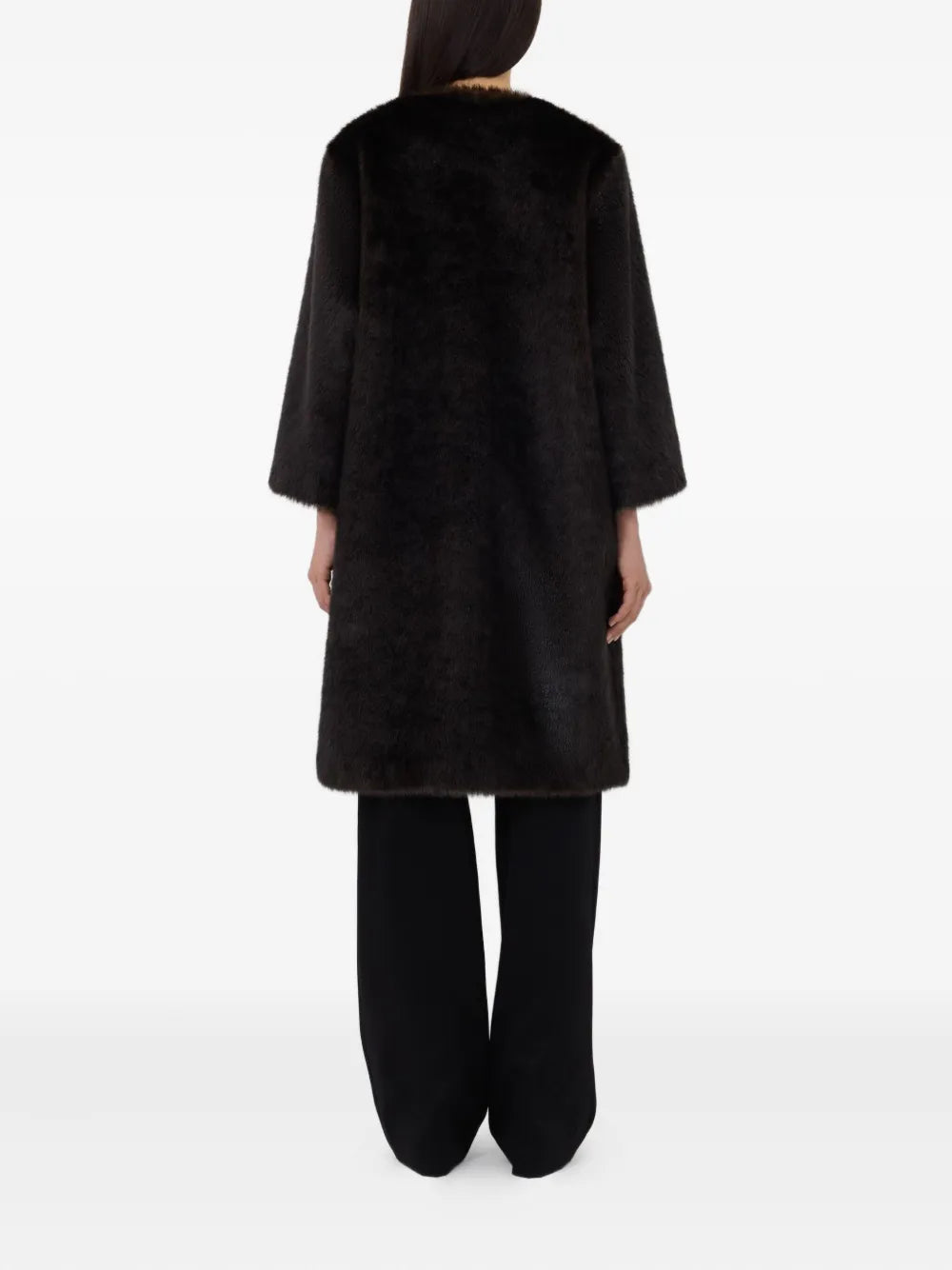 The Moore Faux Fur Coat in Grizzly displayed on a hanger, featuring its minimalistic cut and elegant silhouette