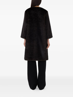 The Moore Faux Fur Coat in Grizzly displayed on a hanger, featuring its minimalistic cut and elegant silhouette