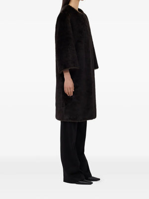 Model wearing the Moore Faux Fur Coat in Grizzly, styled for a trendy winter look