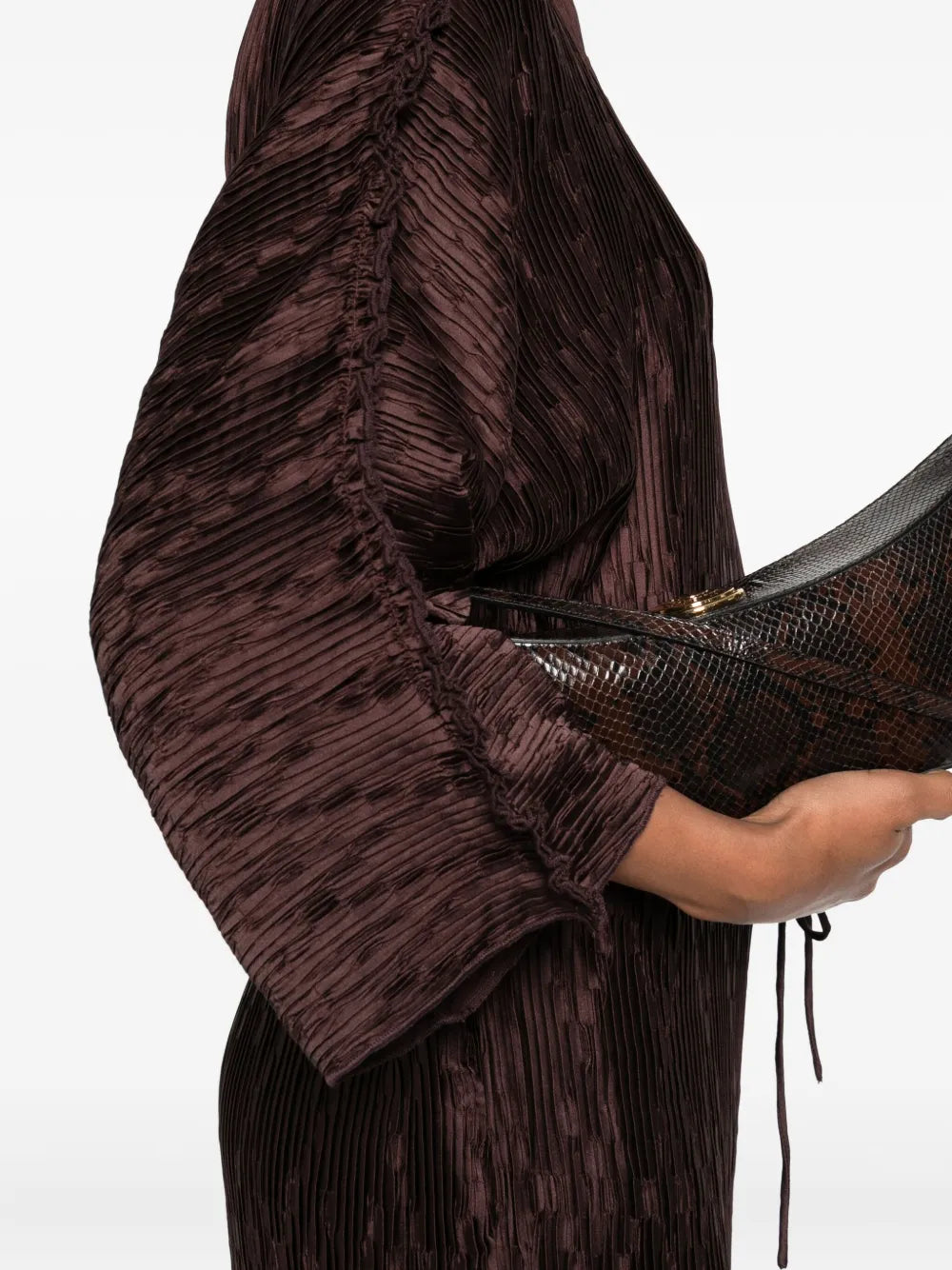Close-up of the Tralaido Dress in Coffee Brown, highlighting its delicate plissé texture and stylish details.
