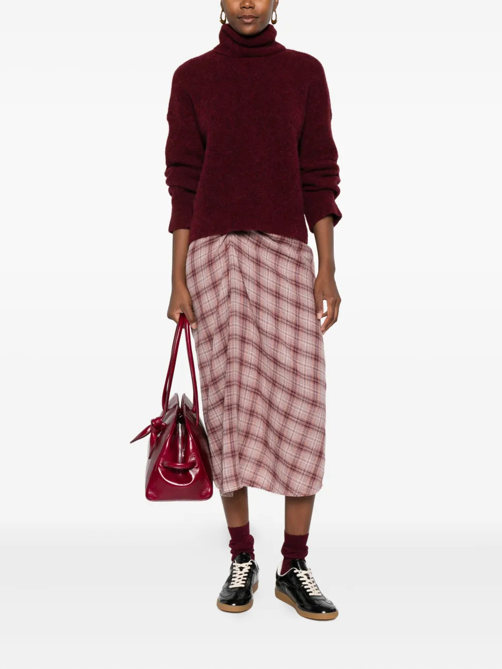 Close-up of the Nicole Skirt in Rosewood by Isabel Marant, highlighting the raw-edge hem and intricate fabric texture.