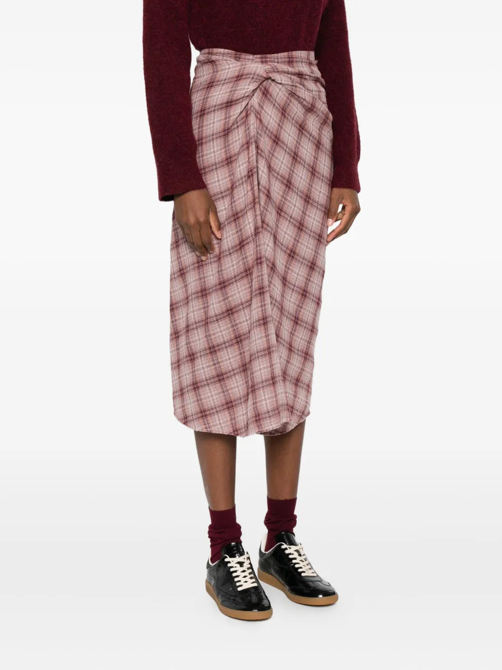 Model wearing the Nicole Skirt in Rosewood, giving a full view of its stylish draped silhouette and tie-front detail.