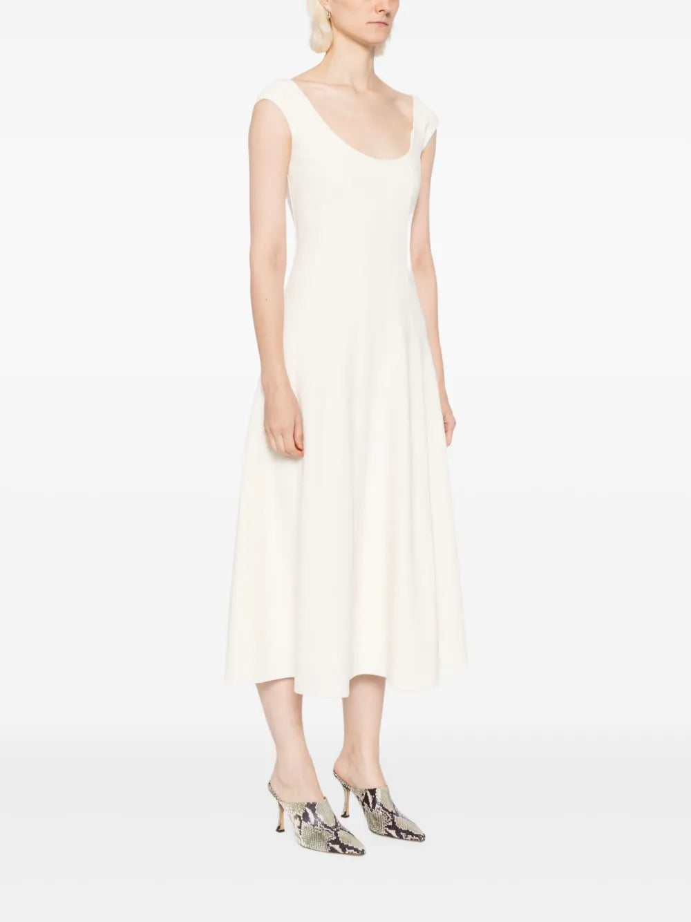 Model wearing Staud Charlotte Dress in Ecru, showcasing its flattering silhouette and midi length.