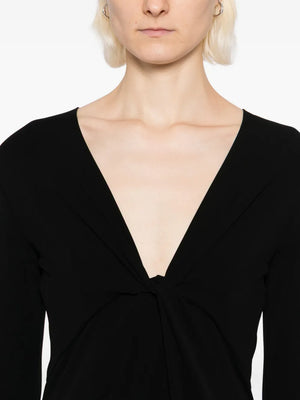 Model wearing the Tavi Dress in Black by Nili Lotan, styled for a chic look with its floor length design.