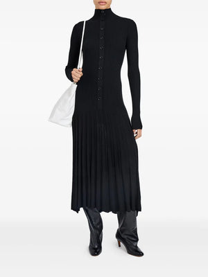 Close-up of the Jada Dress in Black featuring the drop-waist skirt and high-low hem detail.