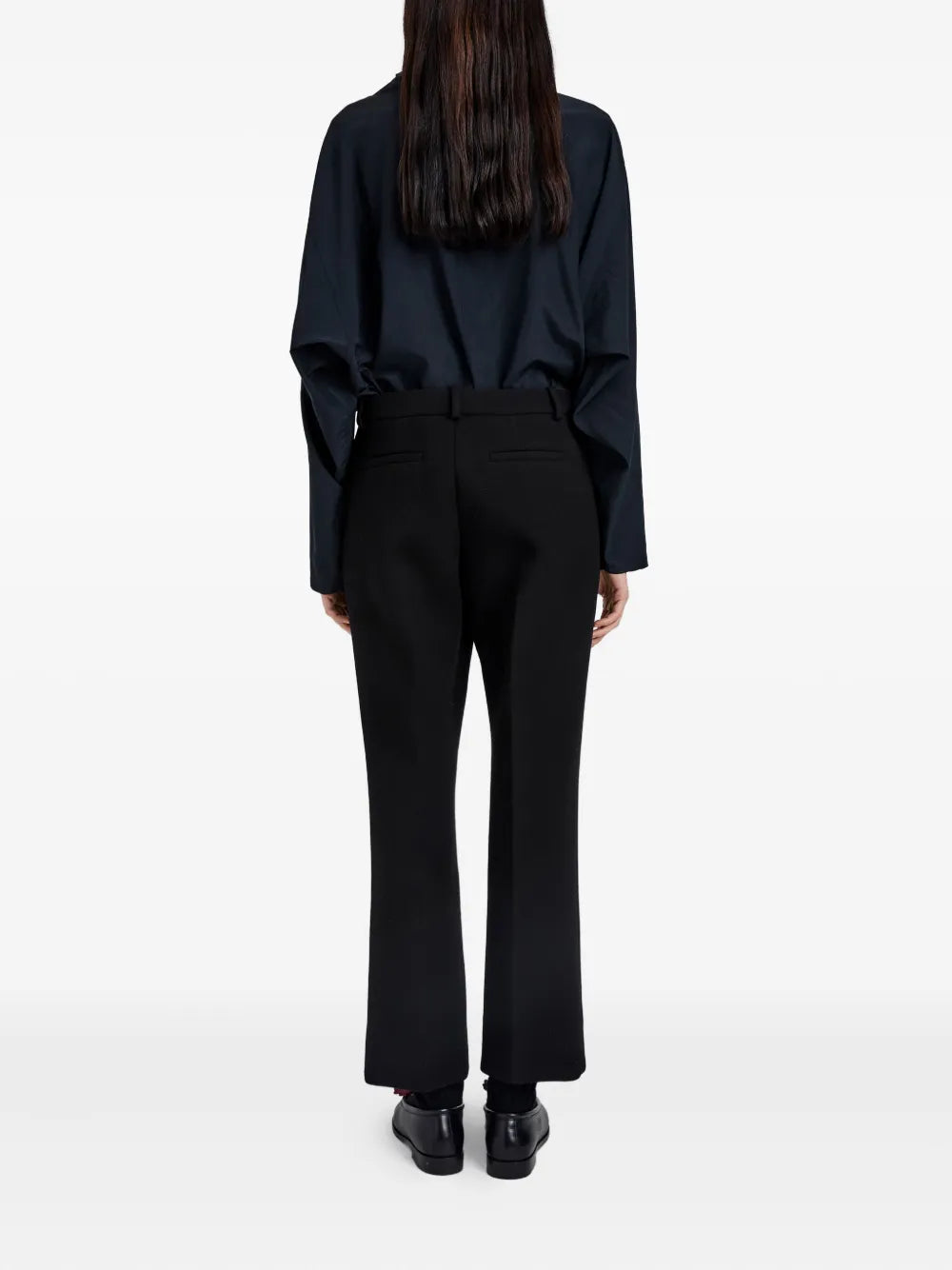 Back view of the Proenza Schouler Ismene Pant in Black, emphasizing the flattering fit and ankle flare design.