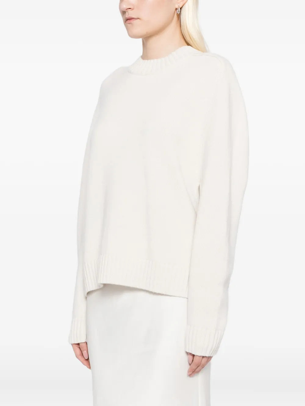 New Saddle Crewneck Sweater in Ivory laid flat to showcase its boxy fit and ribbed finish.
