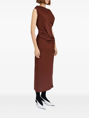 Model wearing the Proenza Schouler Tasa Dress in Mahogany with draped design and ankle-grazing hem.