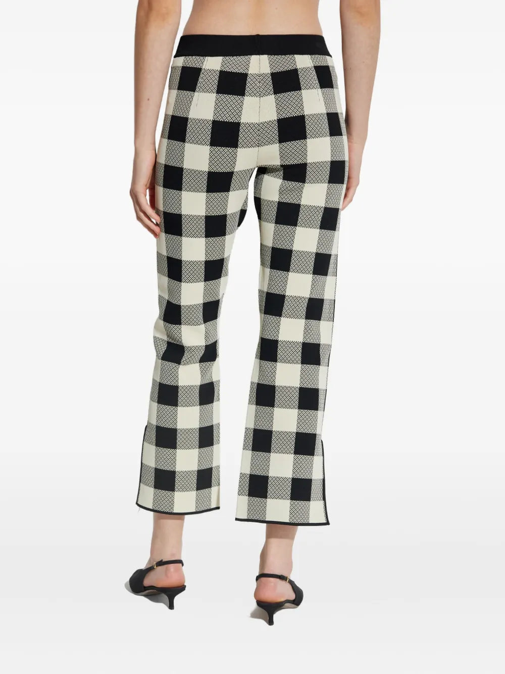 Pippa Pants in Heritage Plaid displayed in a stylish outfit, emphasizing its classic plaid pattern.
