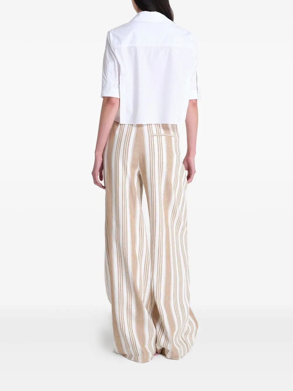 The back view of the Short Lived Shirt in White, highlighting pleats at the sleeves.