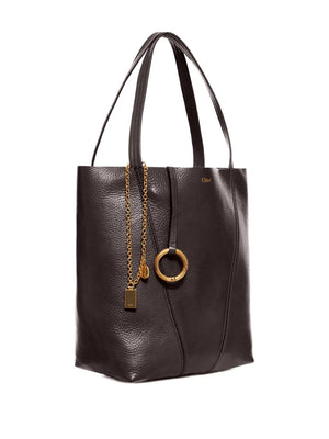 Close-up of the Chloé Spin Tote in Kohl Brown highlighting the signature Chloé and Horse Medals dangling chain.