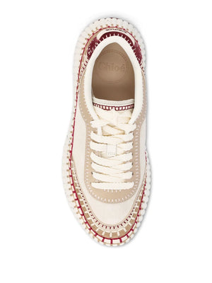 Chloé Nama Sneakers in Beige/Purple set against a neutral background, highlighting their elegant design and color combination.
