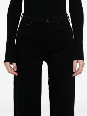 Lyra Long Wide Leg in Plush Black - Lifestyle image featuring the jeans styled with classic sneakers for a chic casual look.