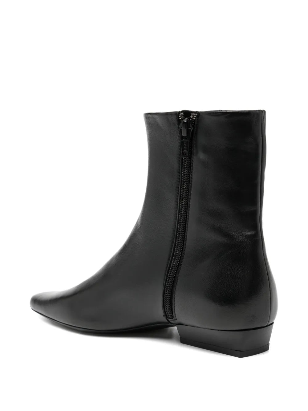Wally Flat Ankle Boot in Black by Staud modeled with casual outfit highlighting its sleek design.