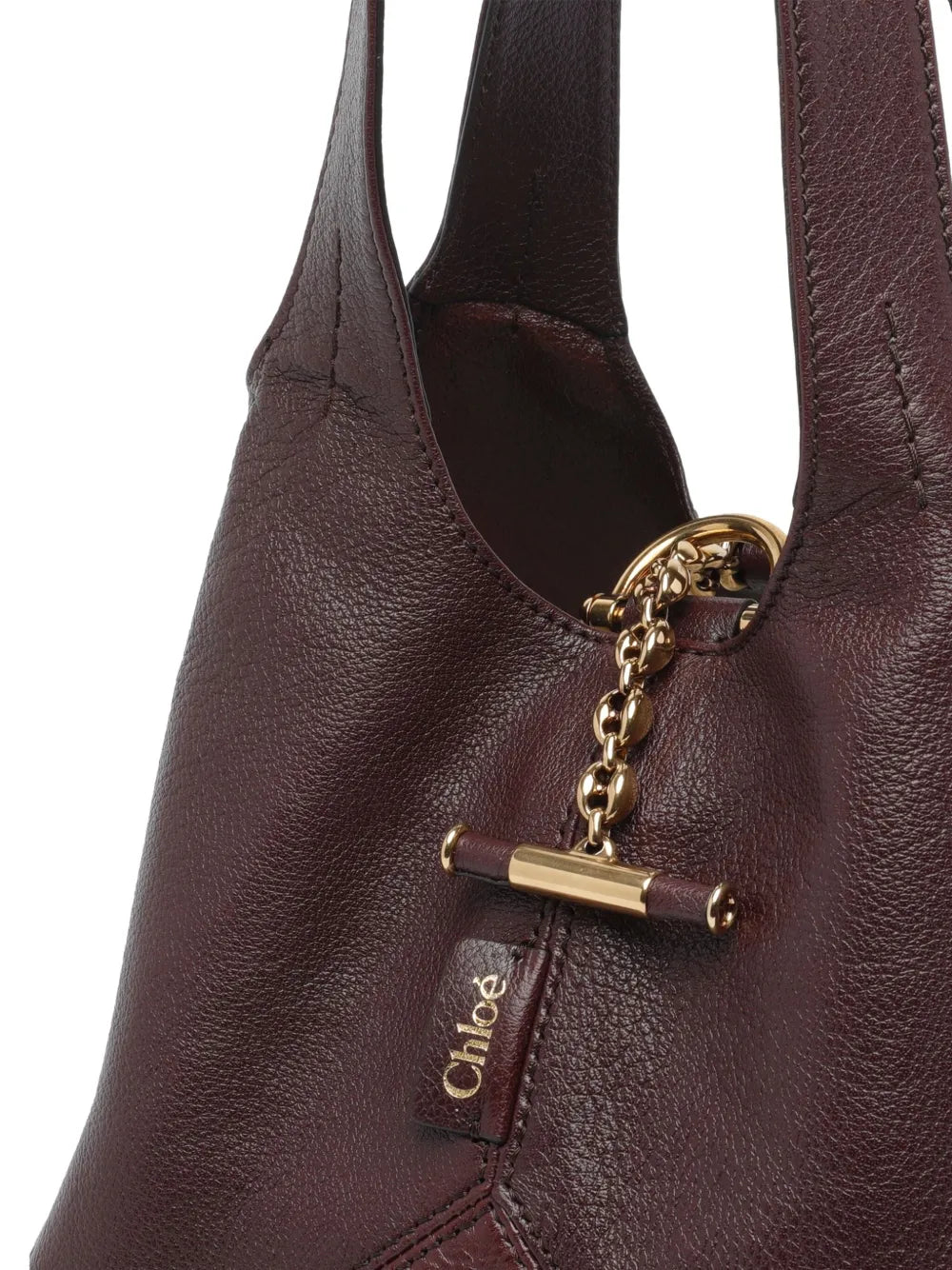 Detailed view of the Small Chloé Balloon Bag in Grenat, featuring the signature Horse Medal at the base.