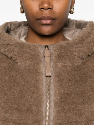 Model wearing the Max Mara Petal04 Cape in Brown, demonstrating its trendy and cozy look.