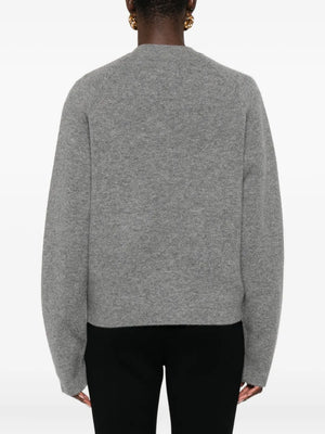Casual outfit styled with the Hammered Botton Cardigan in Grey Melange paired with tonal trousers for a chic look.