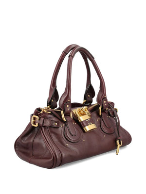 Close-up view of the oversized padlock detail on the Chloé Paddington Bag in Grenat.