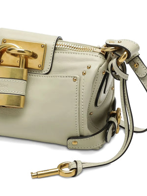 Close-up of the Chloé Small Paddington Chain Bag in Cloudy Cream highlighting the aluminum padlock and luxurious materials.