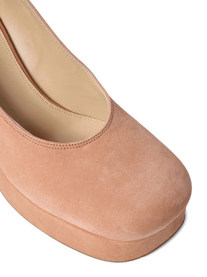 Loti Platform Pump in Peachy Pink from the side, featuring the luxurious lambskin inner and cowhide sole.