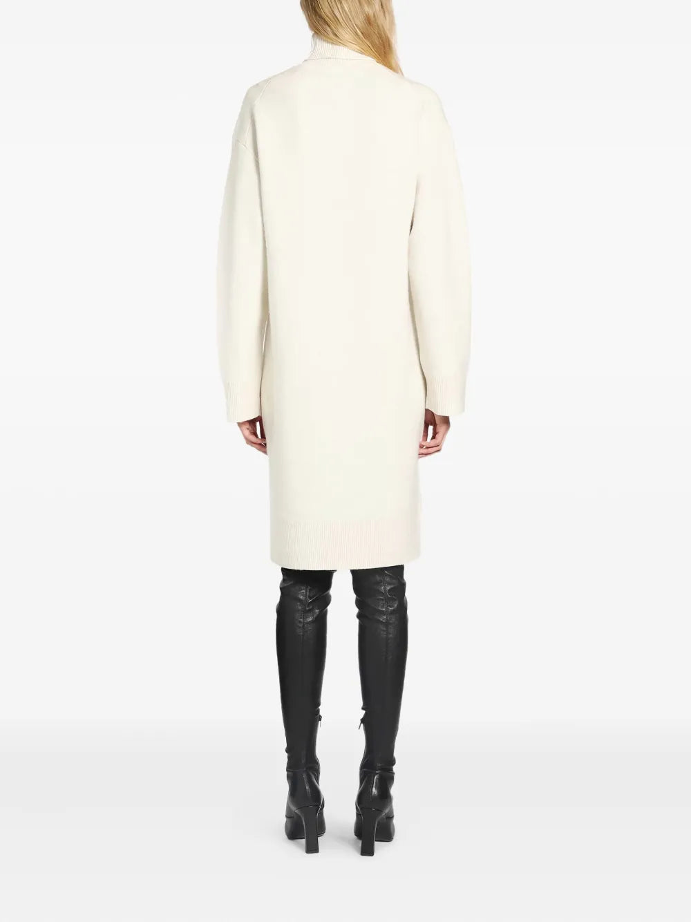 Side view of the Broad Turtleneck Dress in Milk, showing its slightly tapered silhouette.