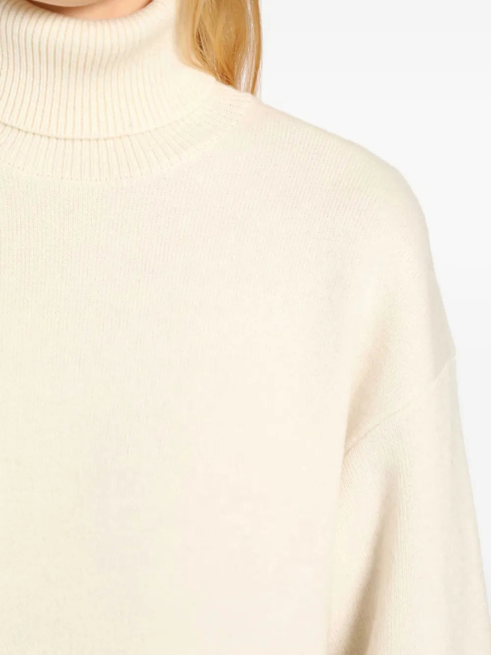Top-down view of the Broad Turtleneck Dress in Milk laid flat, emphasizing its chunky turtleneck and warm colors.