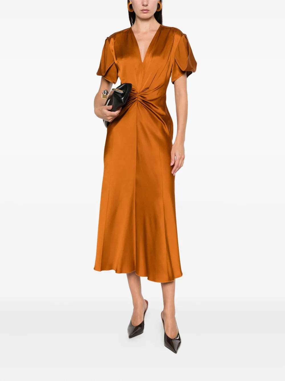 Stylish detail of Eve Midi Dress in Bronze by Victoria Beckham featuring pleat accents and exposed seams for a unique touch.