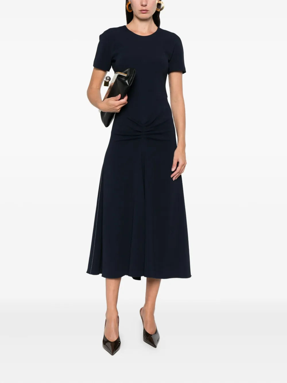 Victoria Beckham's Gathered Detail Dress in Navy, highlighting the relaxed fit through the bodice.