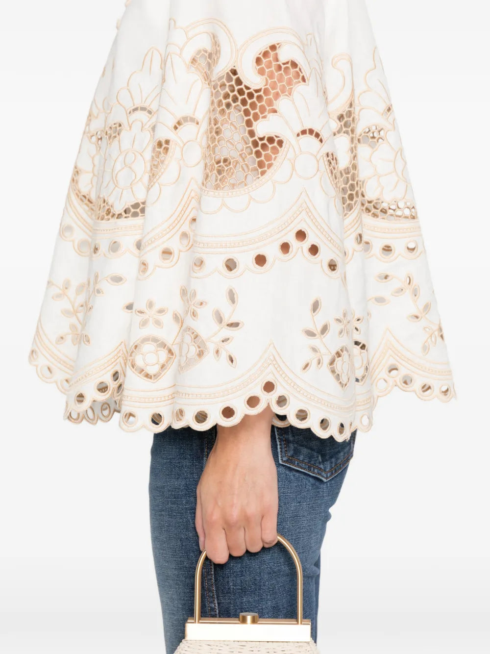 Wanderlust Tunic Top in Ivory by Zimmermann displayed on a hanger, showcasing its sophisticated design and color.