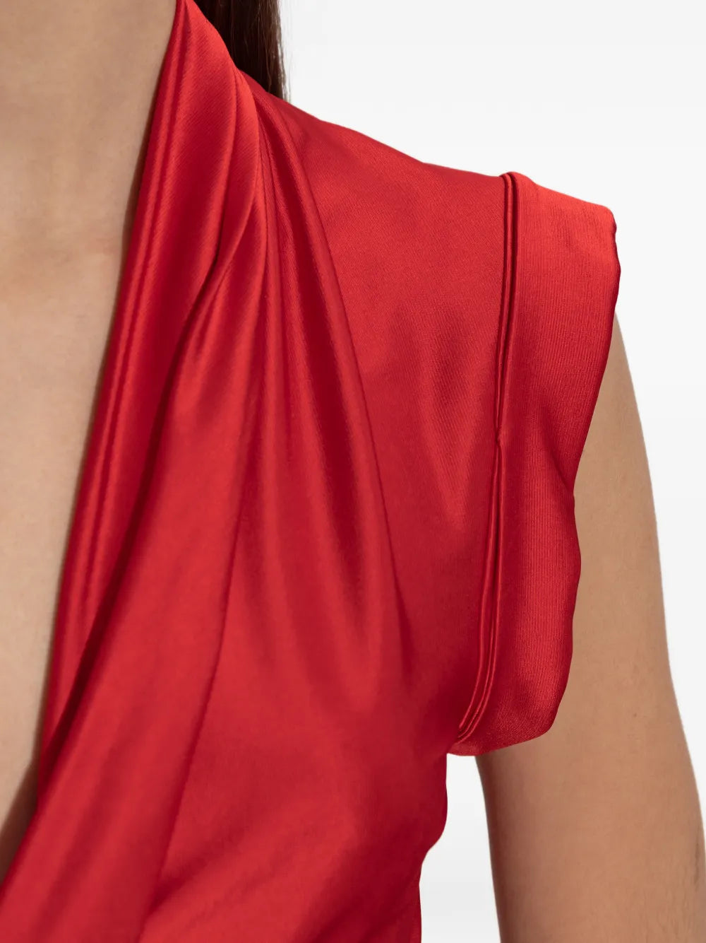 Model wears Victoria Beckham Twist Dress in Cardinal Red emphasizing the stylish drape and confidence in design.