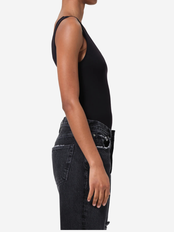 Model wearing the Agolde Tora Tank Bodysuit in Black, demonstrating its body-contouring fit.