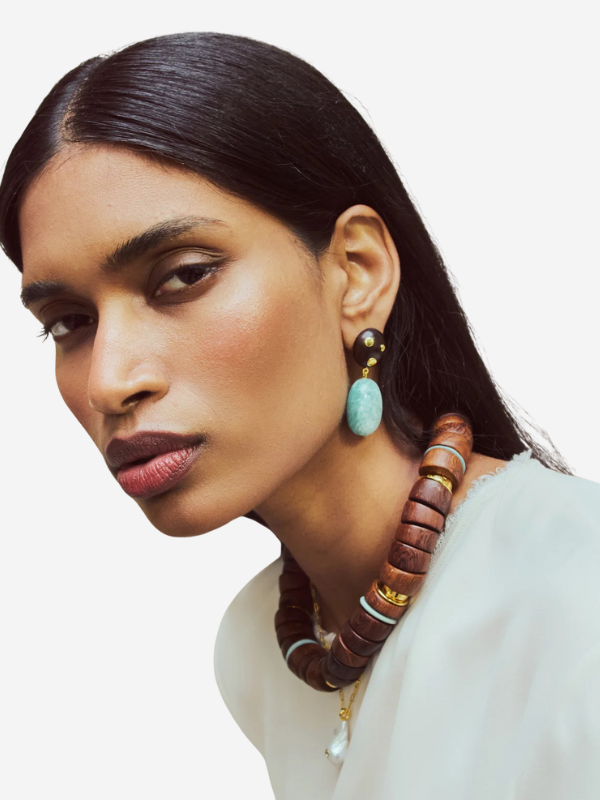 Stylish presentation of Lizzie Fortunato's Las Palmas Collar highlighting its unique design with natural materials and elegant gold details.