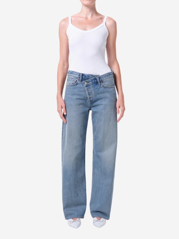 Close-up of Agolde Arc Criss Cross Jean in Conclusion highlighting the medium indigo denim texture and recycled cotton composition.