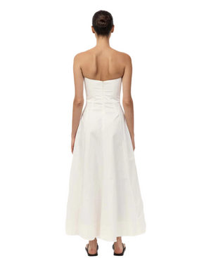 Model wearing the Sculpted Cotton Strapless Dress in Milk, perfect for summer occasions.