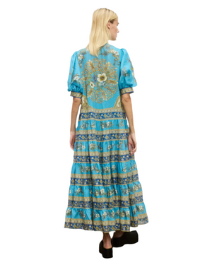 Side view of Cassie Tiered Midi Dress in Blue, showcasing tiered layers and a relaxed silhouette ideal for summer.